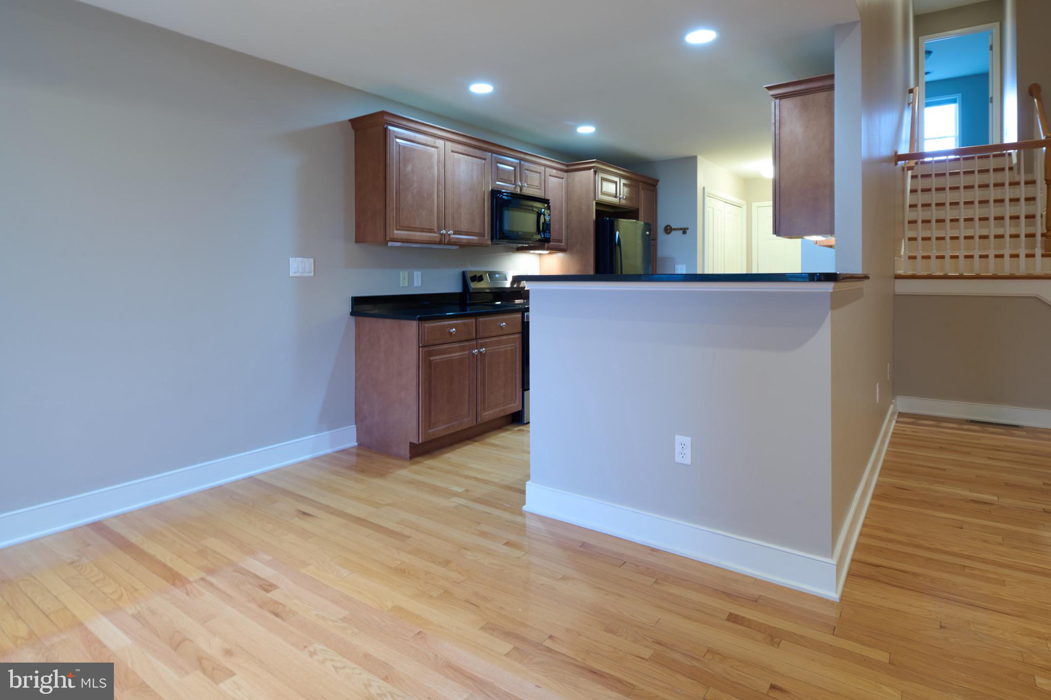3222 Shellers Bend, Unit 209 State College, PA 16801 - Photo 17 of 76 a kitchen with stainless steel appliances granite countertop a refrigerator a sink a stove a microwave and island