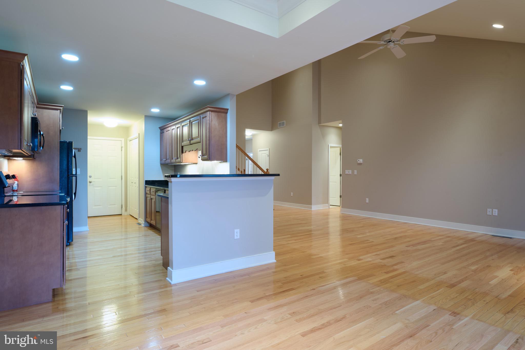 3222 Shellers Bend, Unit 209 State College, PA 16801 - Photo 18 of 76 a view of kitchen with kitchen island granite countertop wooden floor and stainless steel appliances