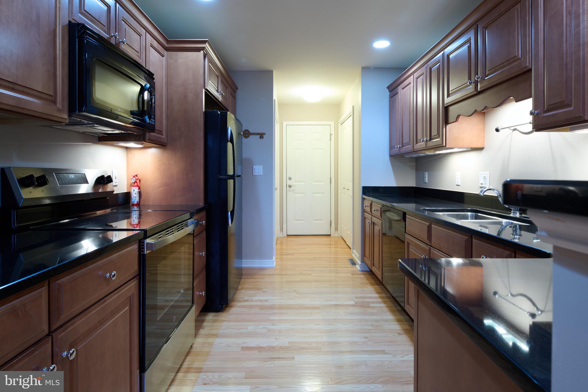3222 Shellers Bend, Unit 209 State College, PA 16801 - Photo 20 of 76 a kitchen with stainless steel appliances granite countertop a stove and a refrigerator