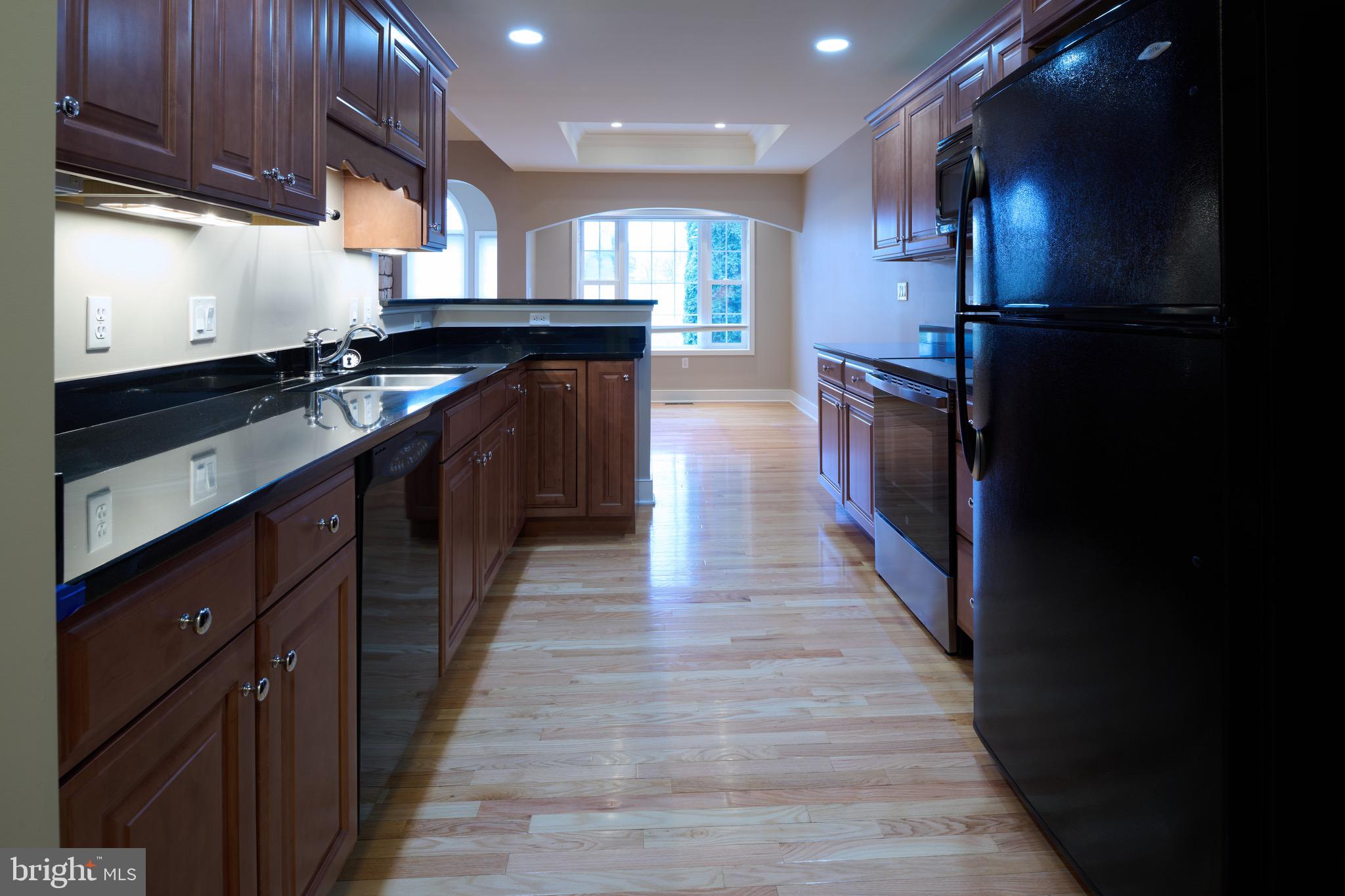 3222 Shellers Bend, Unit 209 State College, PA 16801 - Photo 21 of 76 a kitchen with stainless steel appliances granite countertop a stove a sink and a refrigerator