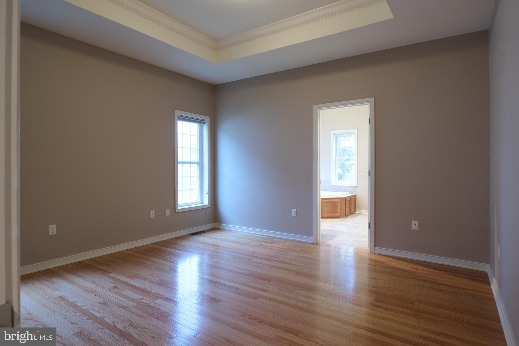 3222 Shellers Bend, Unit 209 State College, PA 16801 - Photo 30 of 76 a view of an empty room with wooden floor and a window