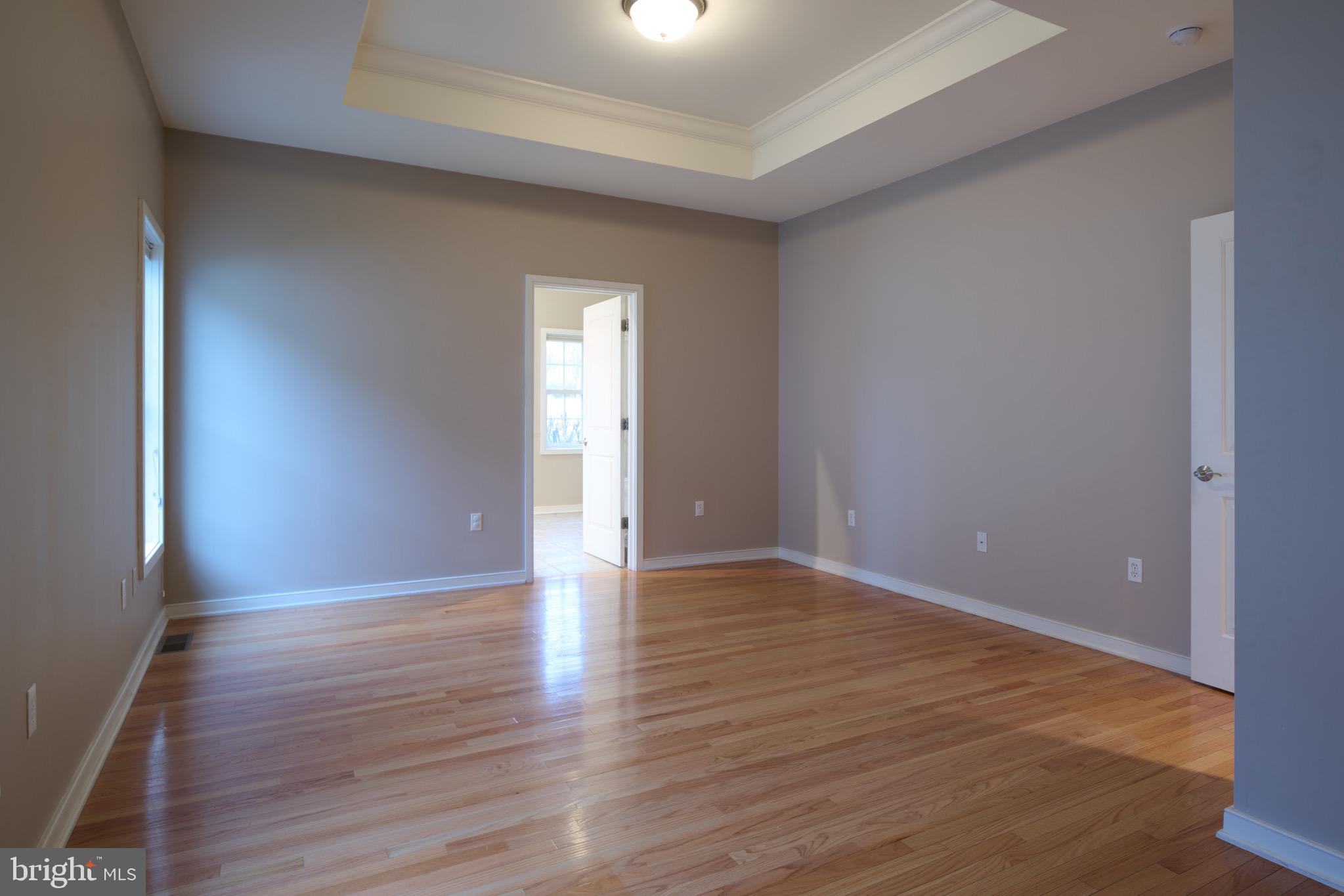 3222 Shellers Bend, Unit 209 State College, PA 16801 - Photo 33 of 76 a view of an empty room with wooden floor and a window