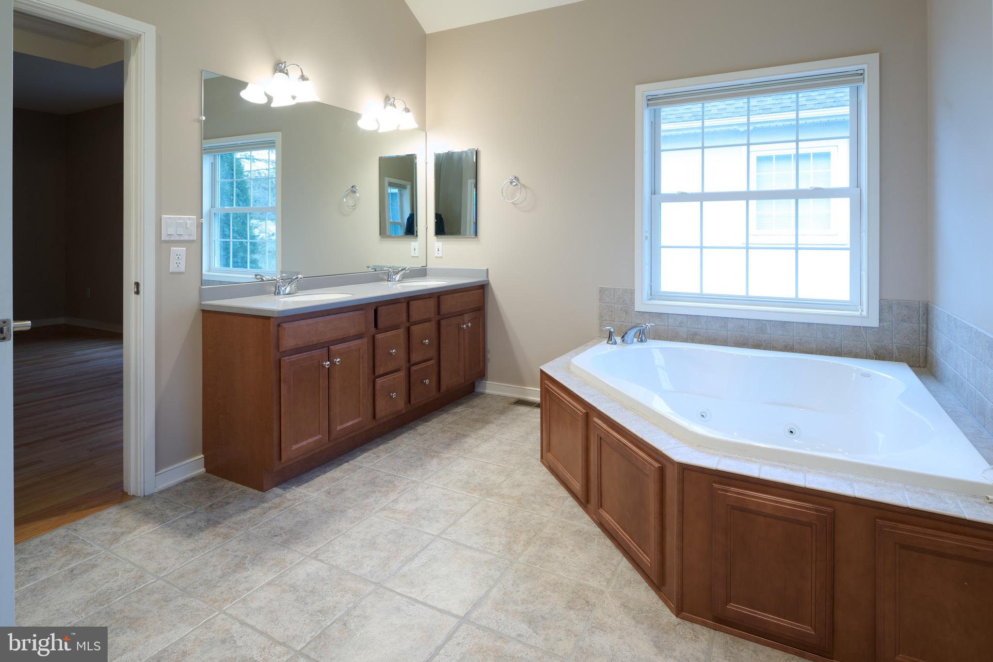 3222 Shellers Bend, Unit 209 State College, PA 16801 - Photo 37 of 76 a spacious bathroom with a tub sink and mirror