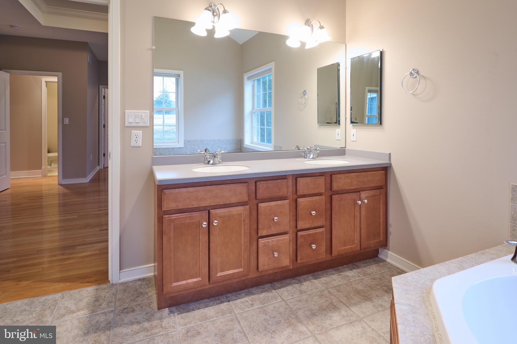 3222 Shellers Bend, Unit 209 State College, PA 16801 - Photo 39 of 76 a spacious bathroom with a double vanity sink a mirror and a shower