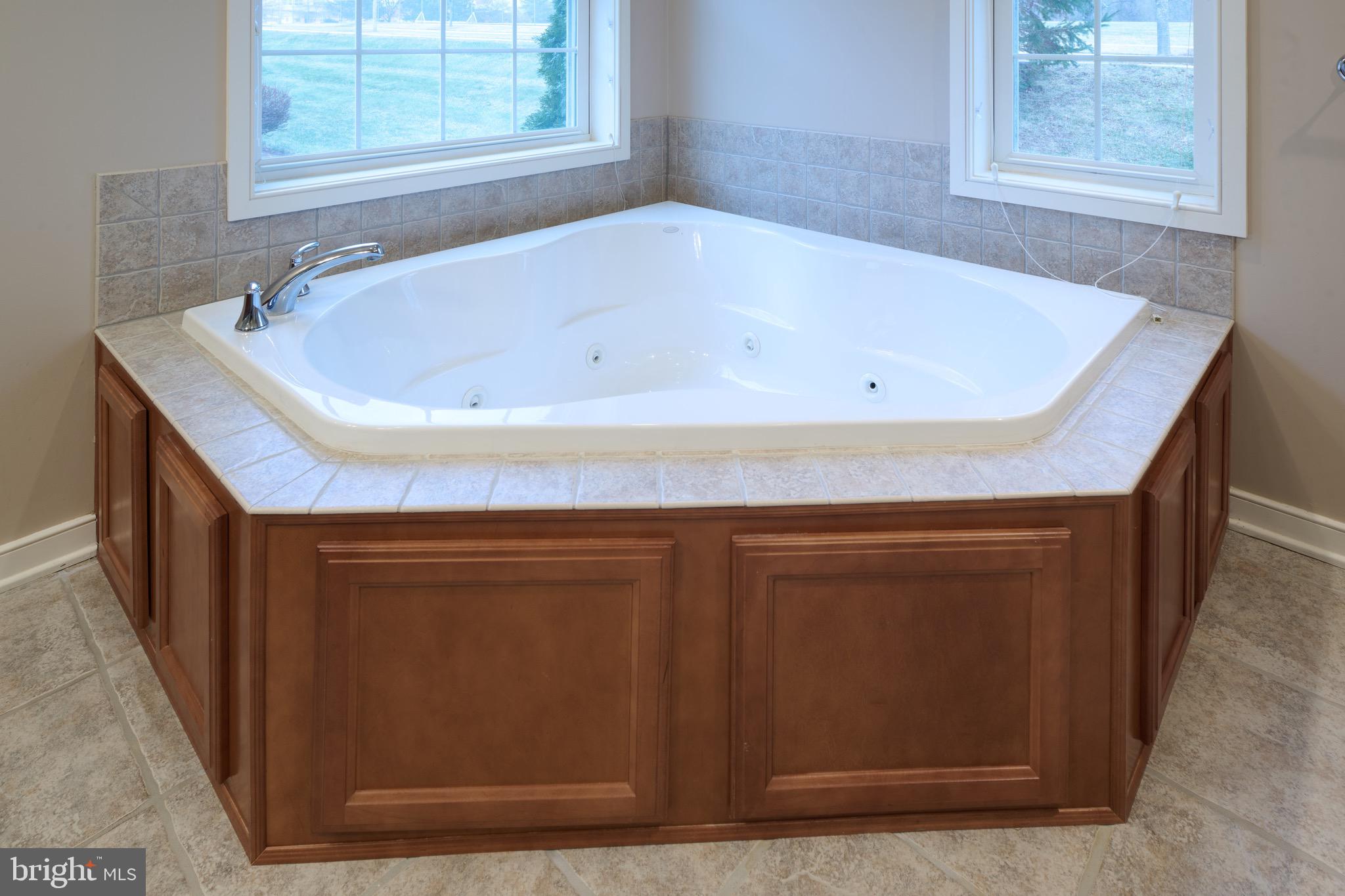 3222 Shellers Bend, Unit 209 State College, PA 16801 - Photo 40 of 76 a bathroom with a bathtub and a window
