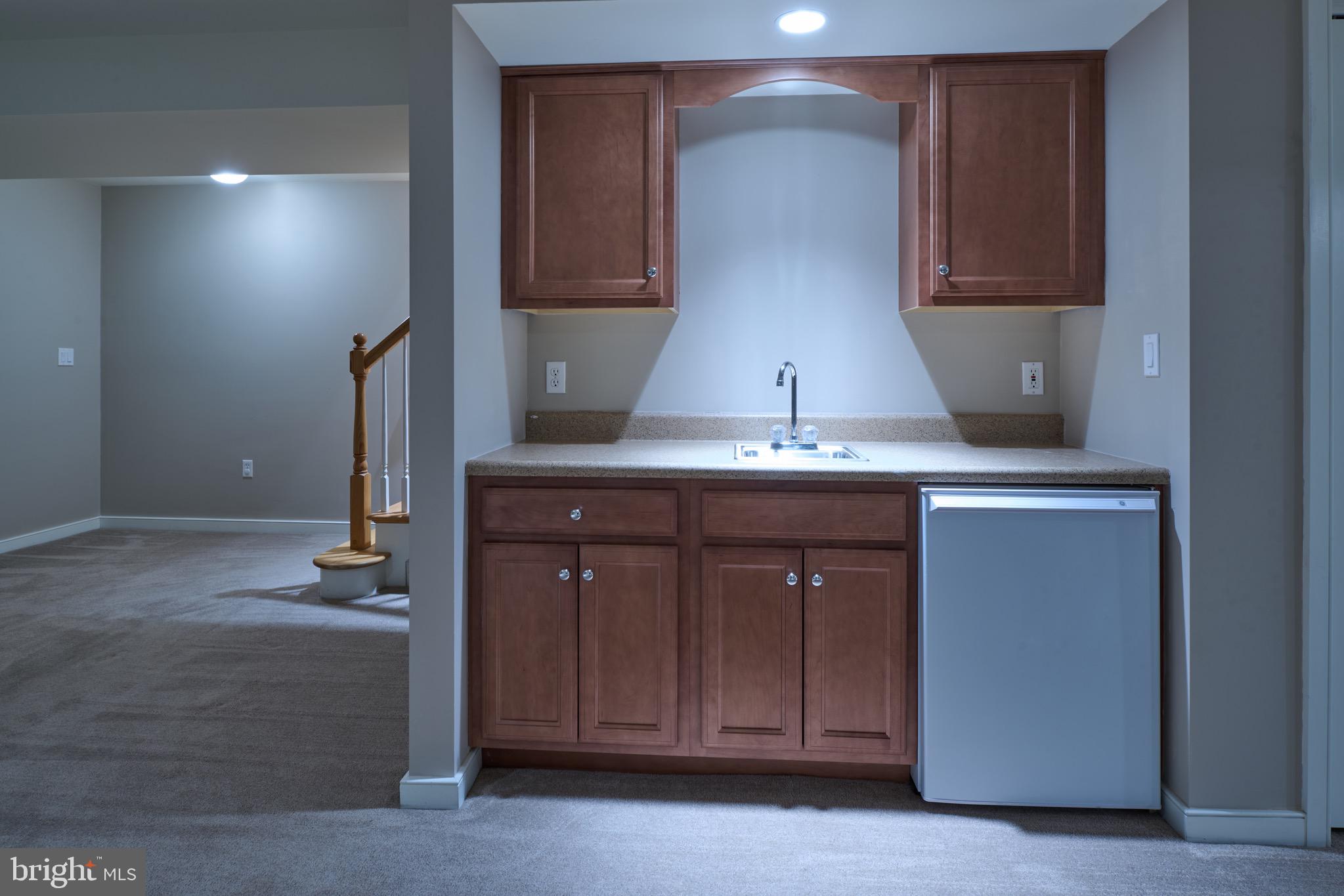 3222 Shellers Bend, Unit 209 State College, PA 16801 - Photo 44 of 76 a kitchen with a sink and a mirror