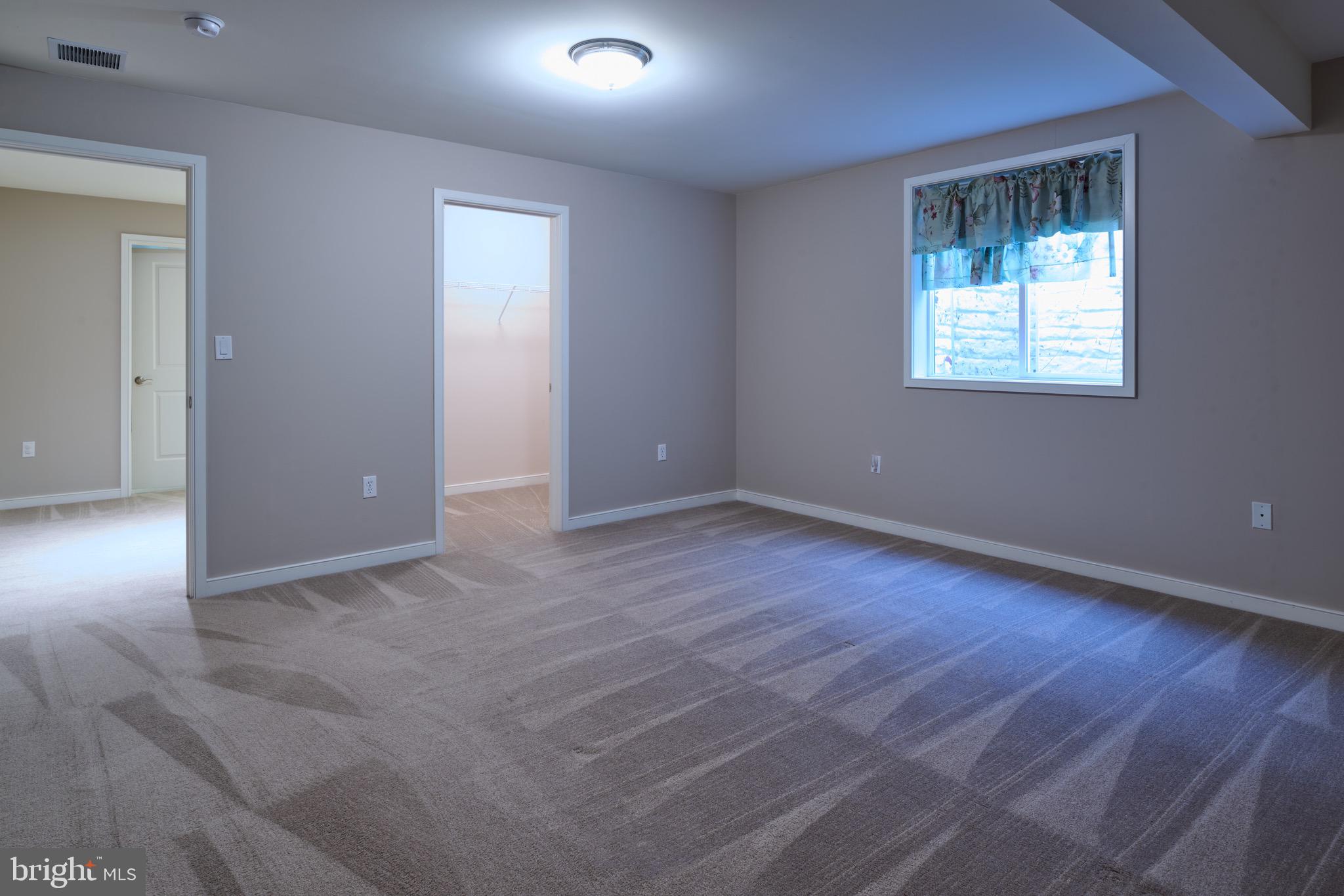 3222 Shellers Bend, Unit 209 State College, PA 16801 - Photo 52 of 76 an empty room with wooden floor cabinet and windows