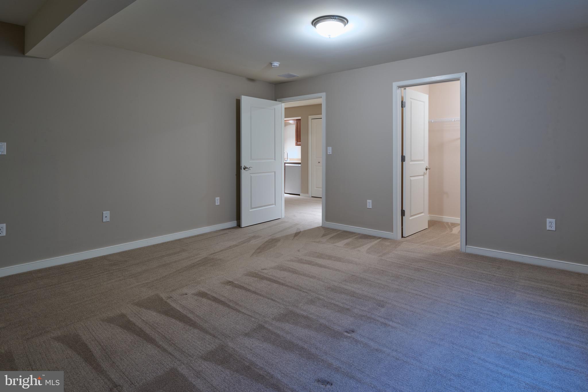 3222 Shellers Bend, Unit 209 State College, PA 16801 - Photo 53 of 76 a view of an empty room with wooden floor and closet