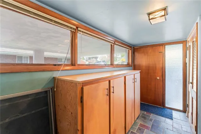 a view of a house with a big yard and large trees