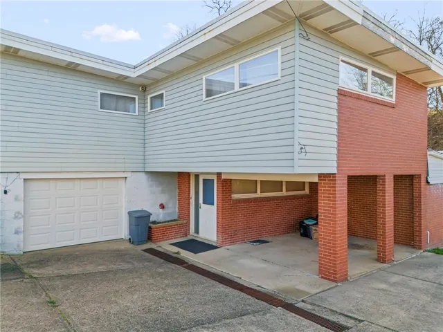 a view of a porch with a table and chairs