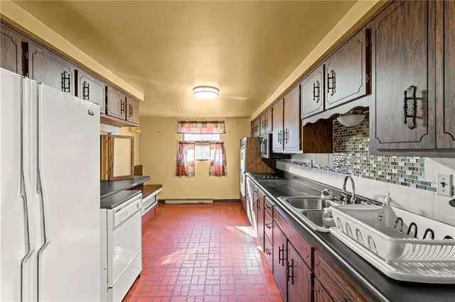 a kitchen with stainless steel appliances granite countertop a stove and a sink