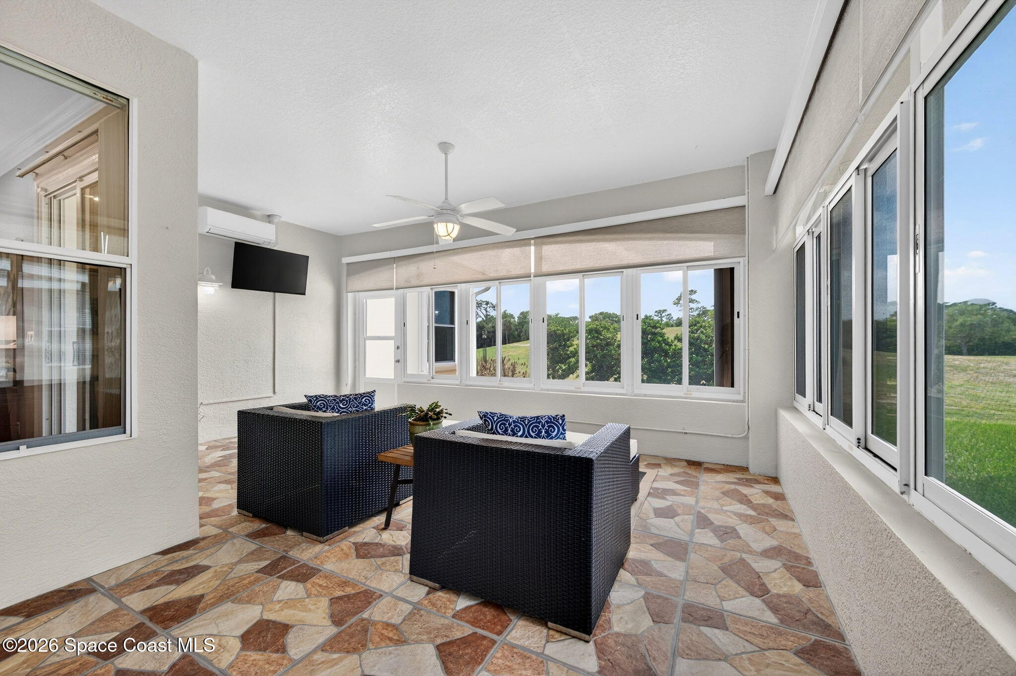 4331 Aberdeen Circle Rockledge, FL 32955 - Photo 23 of 36 a living room with stainless steel appliances granite countertop furniture a fireplace and a large window