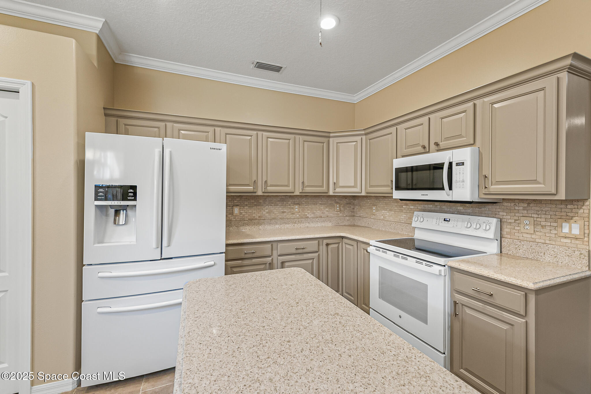 4331 Aberdeen Circle Rockledge, FL 32955 - Photo 24 of 63 a kitchen with white cabinets and stainless steel appliances