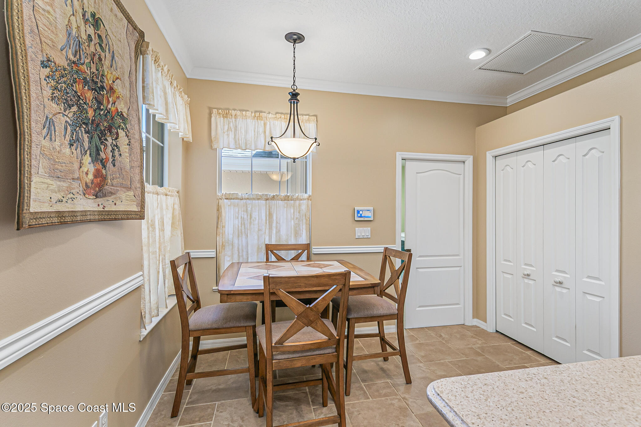 4331 Aberdeen Circle Rockledge, FL 32955 - Photo 26 of 63 a view of a dining room with furniture and chandelier