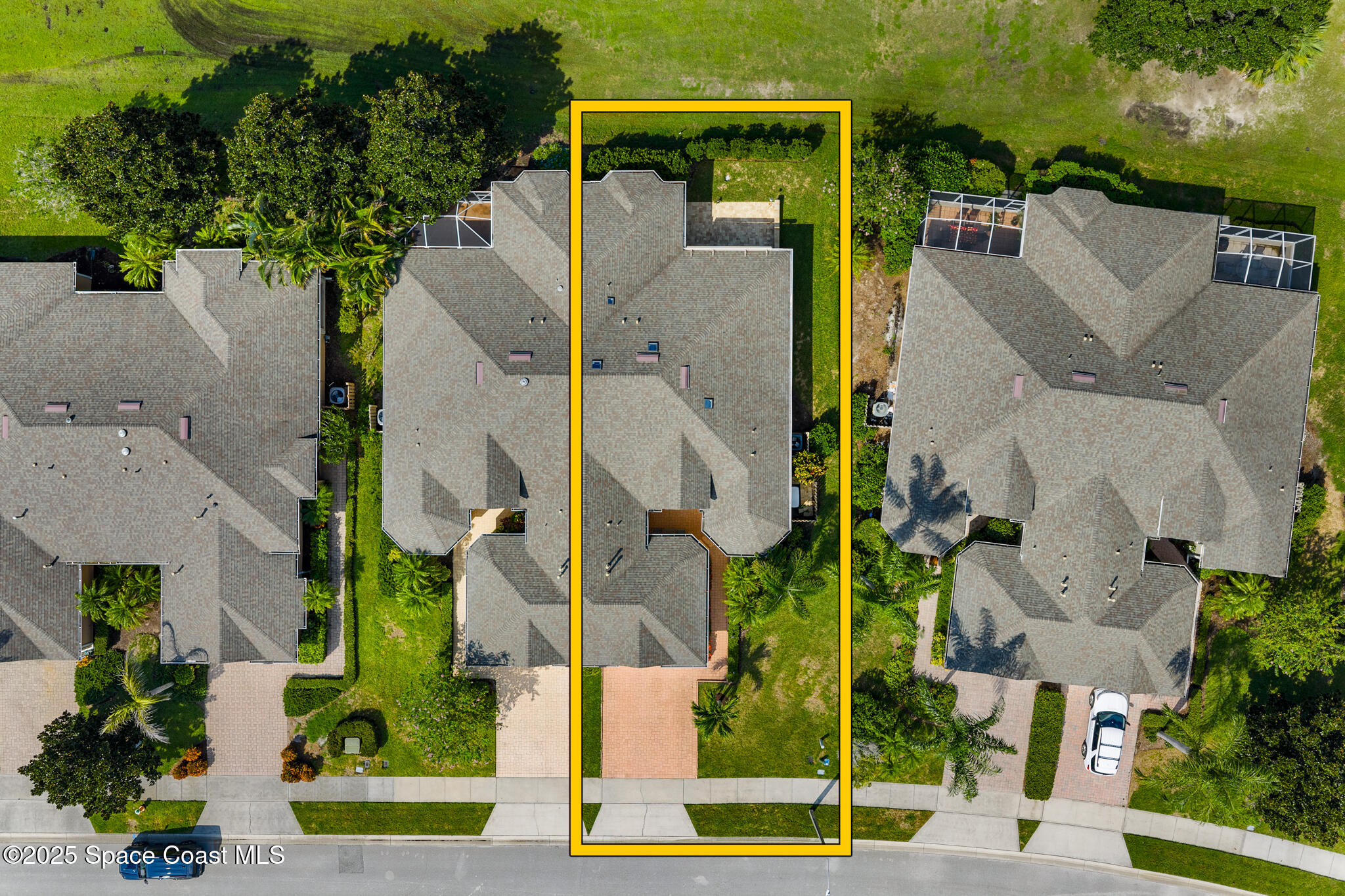4331 Aberdeen Circle Rockledge, FL 32955 - Photo 35 of 36 an aerial view of a house with a yard and lawn chairs under an umbrella