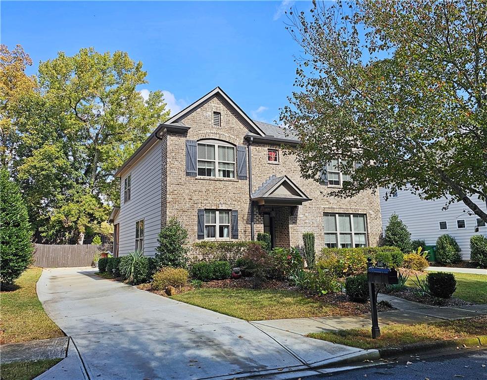 a front view of a house with garden