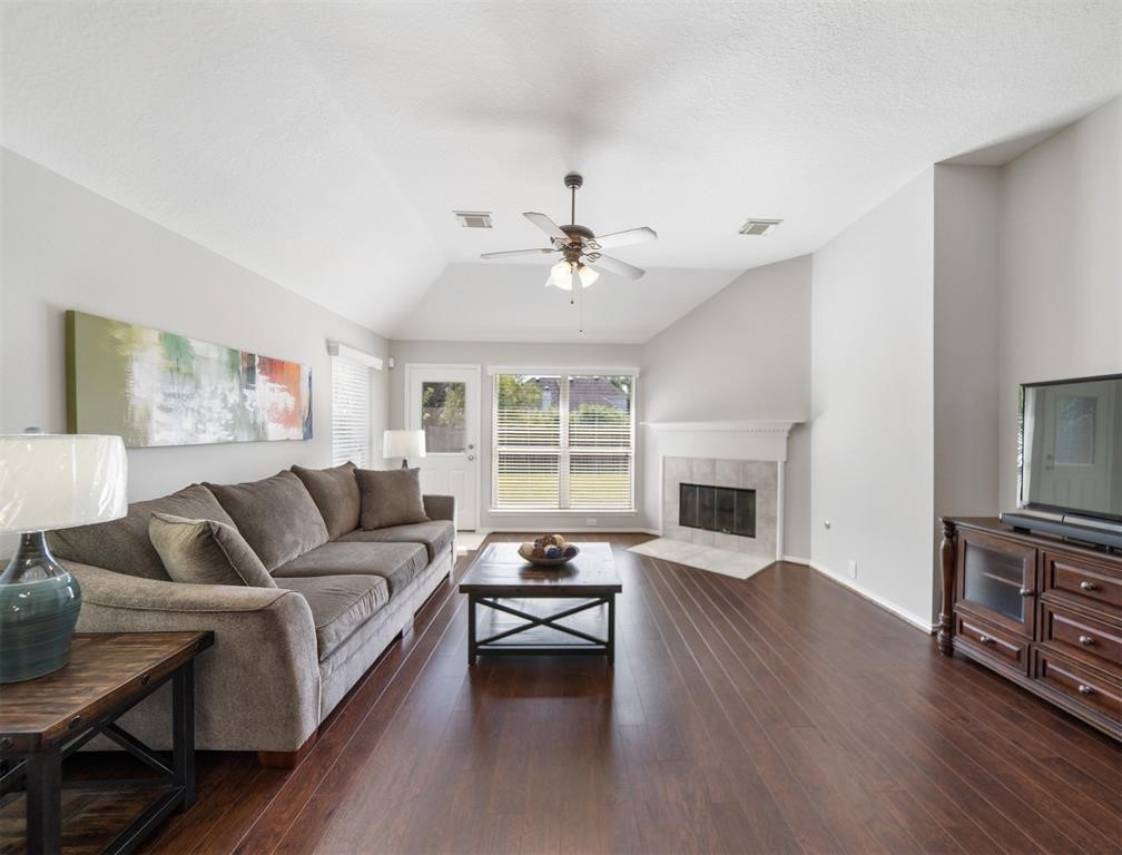 19715 Youpon Leaf Way Houston, TX 77084 - Photo 11 of 20 a living room with furniture fireplace and a large window