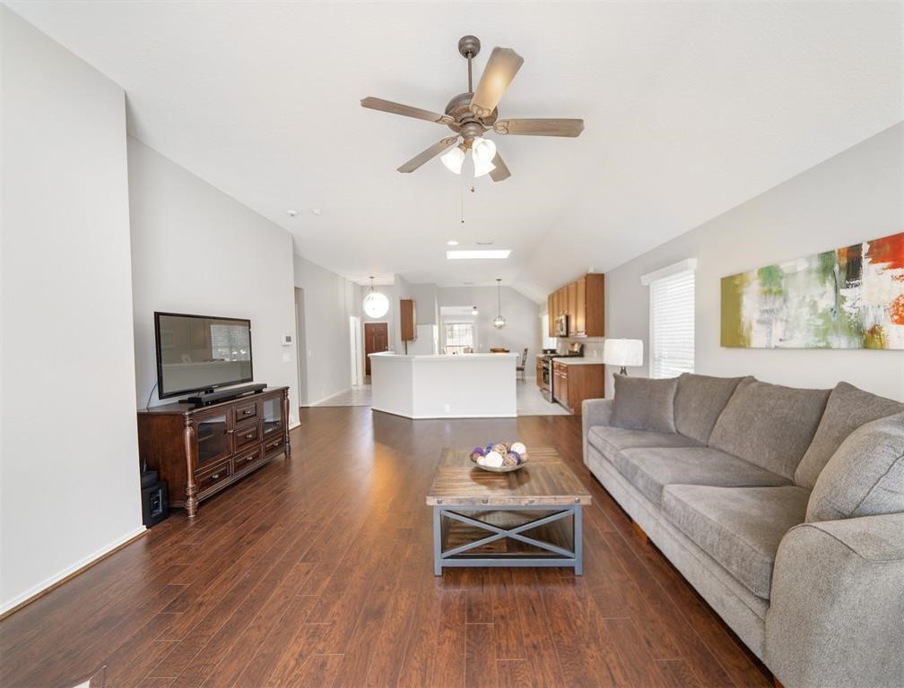 19715 Youpon Leaf Way Houston, TX 77084 - Photo 12 of 20 a living room with furniture kitchen view and a wooden floor