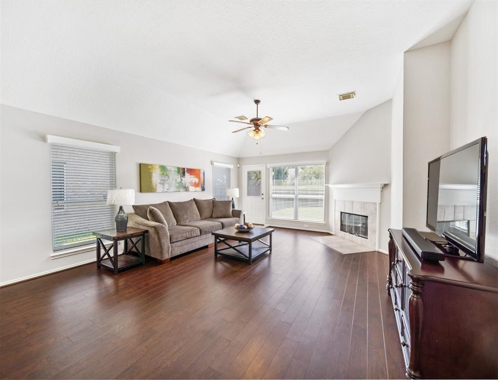 19715 Youpon Leaf Way Houston, TX 77084 - Photo 13 of 20 a living room with furniture and a flat screen tv with wooden floor