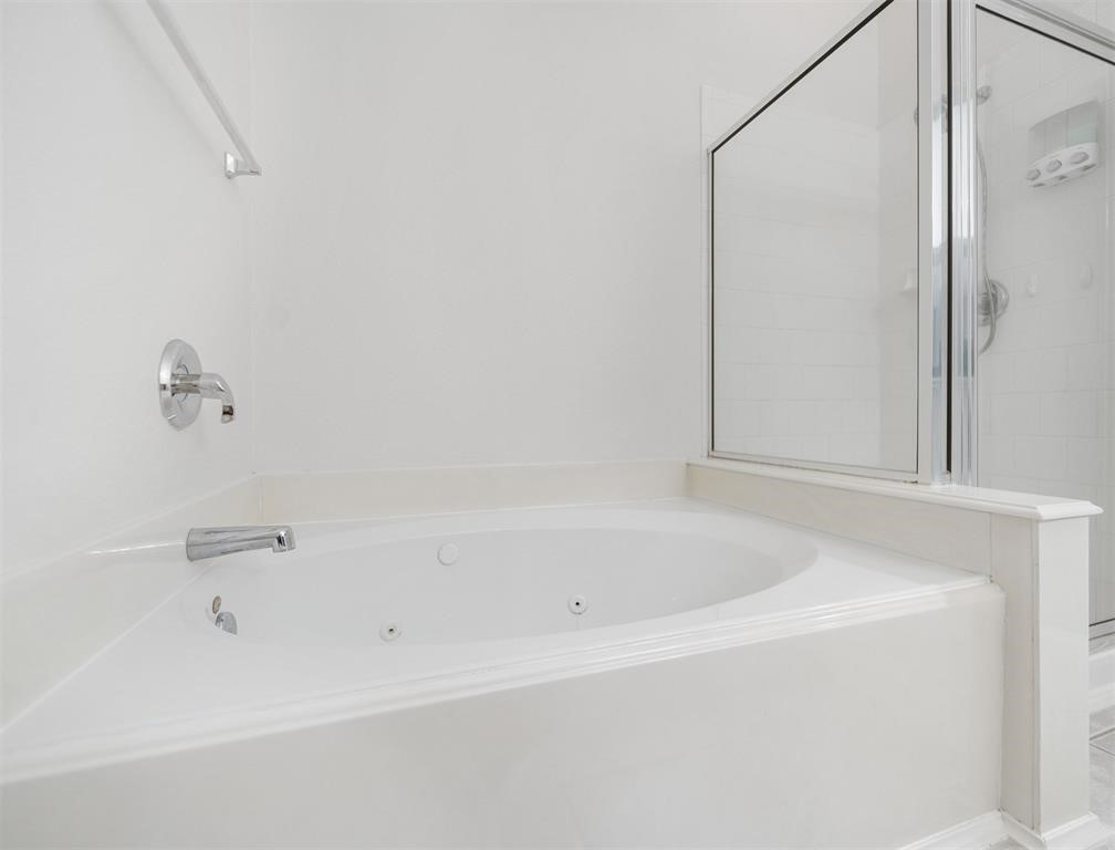19715 Youpon Leaf Way Houston, TX 77084 - Photo 16 of 20 a white bath tub sitting next to a shower