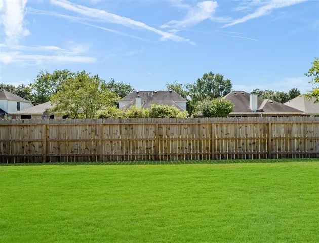 a view of a yard with a fence