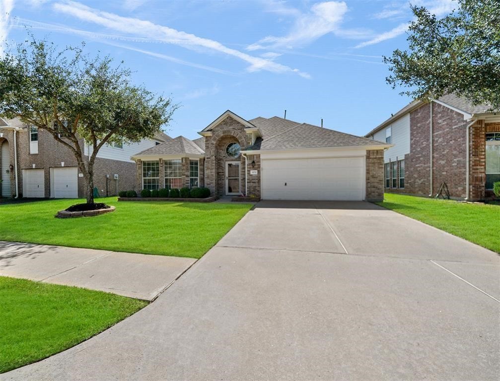 19715 Youpon Leaf Way Houston, TX 77084 - Photo 2 of 20 a front view of a house with a yard and garage