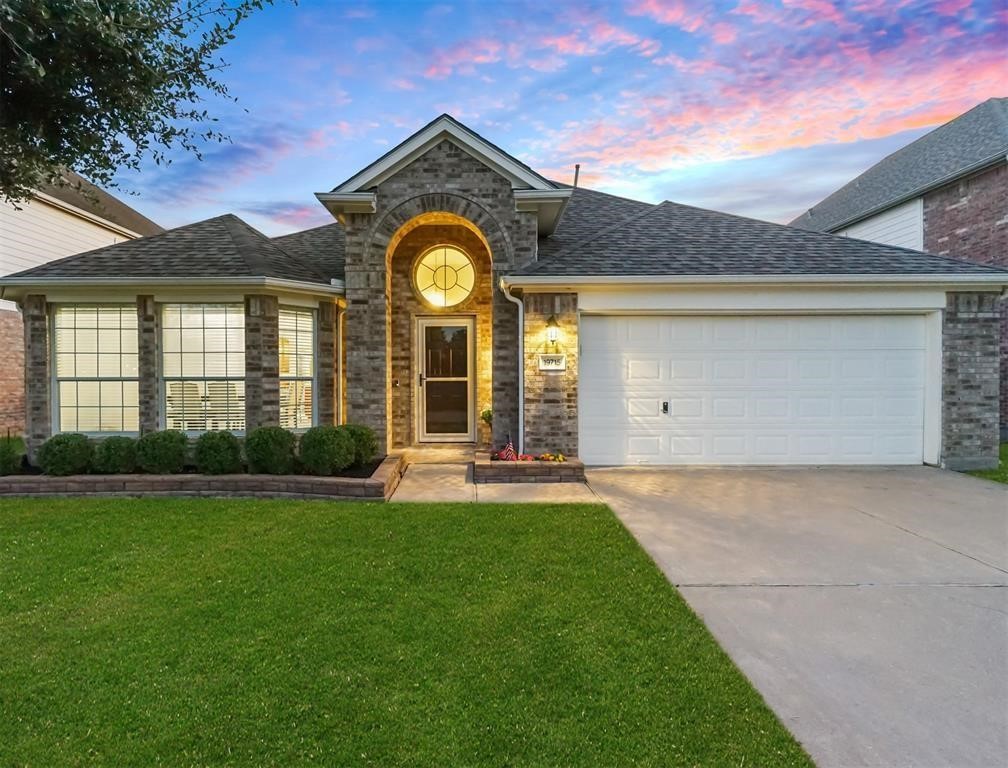 19715 Youpon Leaf Way Houston, TX 77084 - Photo 4 of 20 a front view of a house with a garden and yard