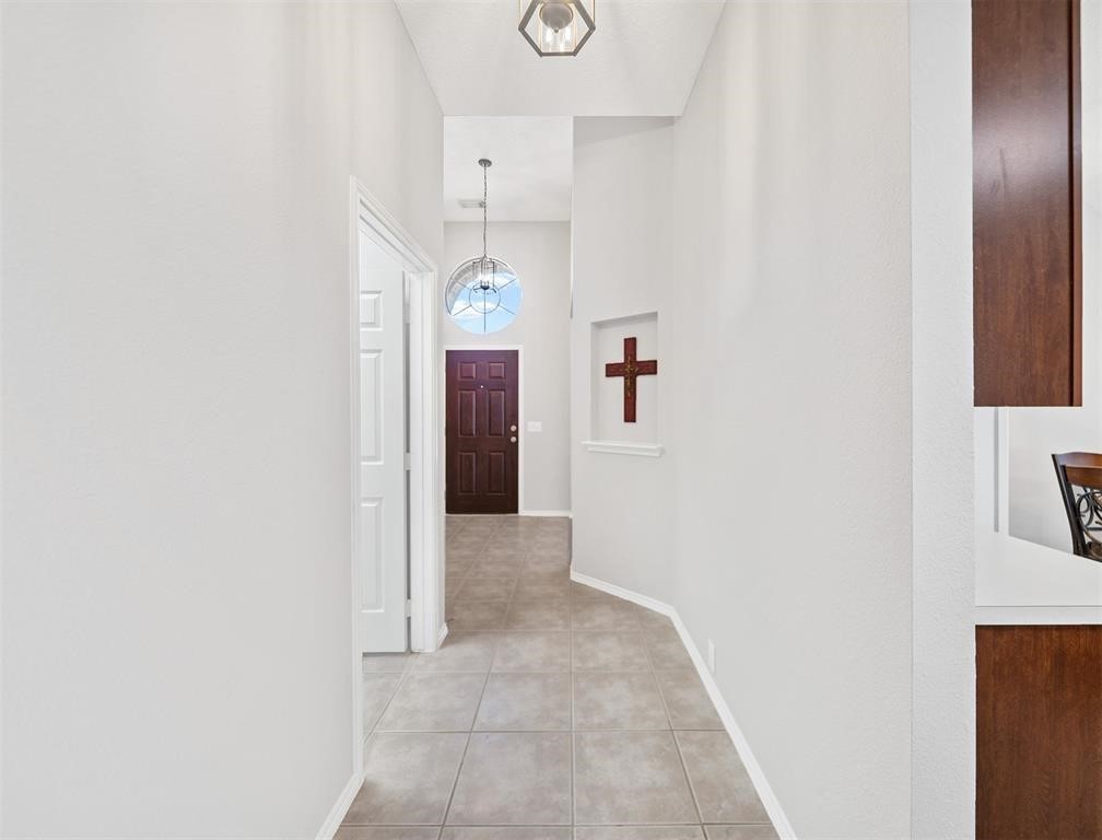 19715 Youpon Leaf Way Houston, TX 77084 - Photo 5 of 20 a view of hallway with kitchen and white cabinets