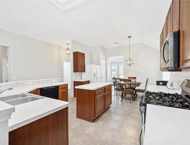 a kitchen with cabinets and wooden floor
