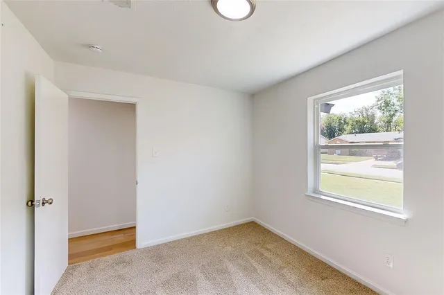 a bathroom with a granite countertop sink vanity mirror and toilet