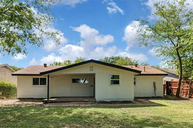 a house with green field in front of it