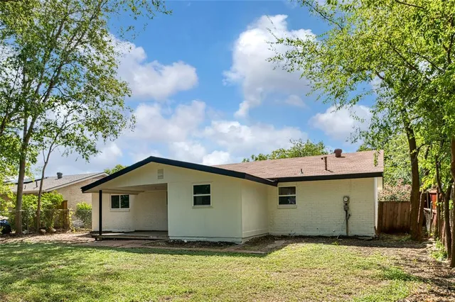 a view of a lake with a big yard and large trees