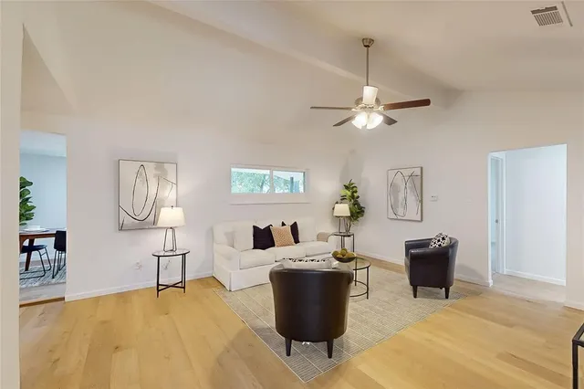 a living room with furniture and a lamp
