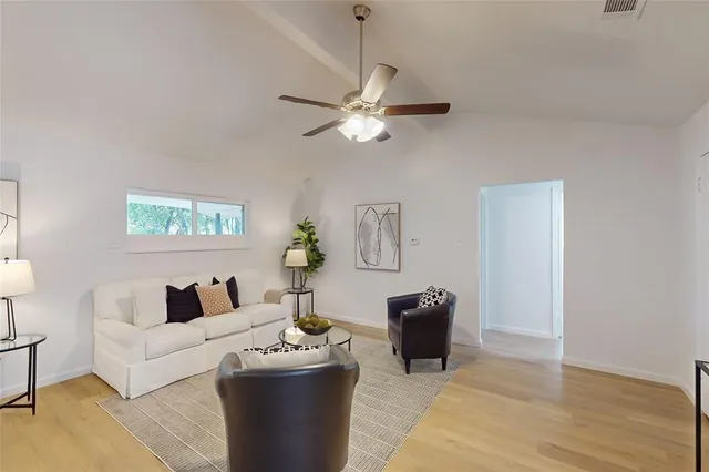 a living room with furniture and a lamp