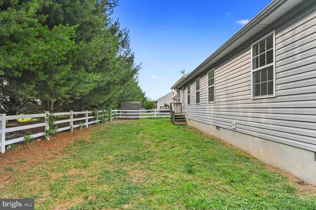 a view of a backyard with sitting area