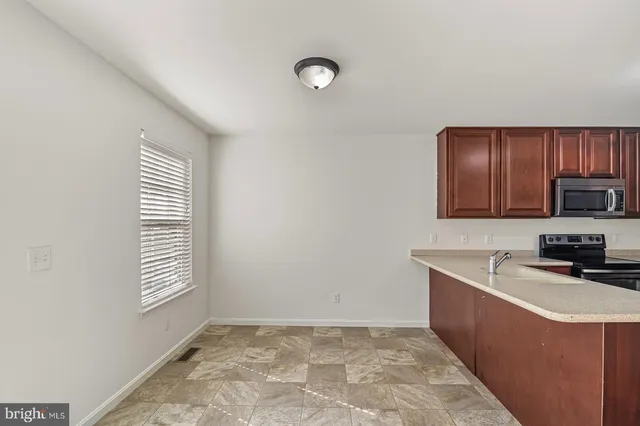 a kitchen with stainless steel appliances granite countertop a sink stove and cabinets