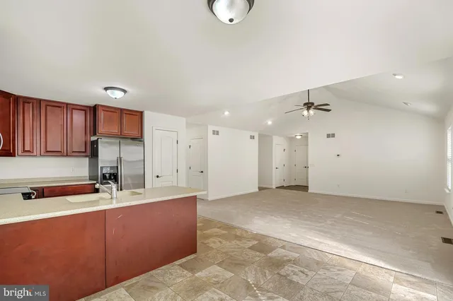 a kitchen with kitchen island a sink stainless steel appliances and cabinets