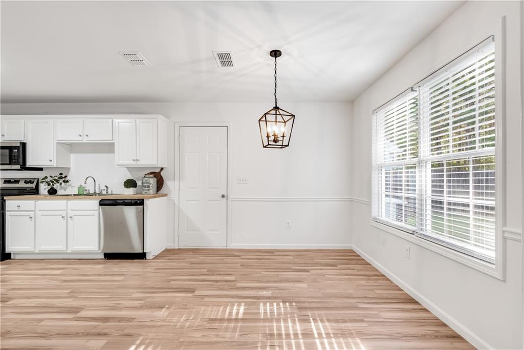 125 Pine Ridge Trace Athens, GA 30605 - Photo 7 of 28 a kitchen with a refrigerator a stove top oven a sink and a window