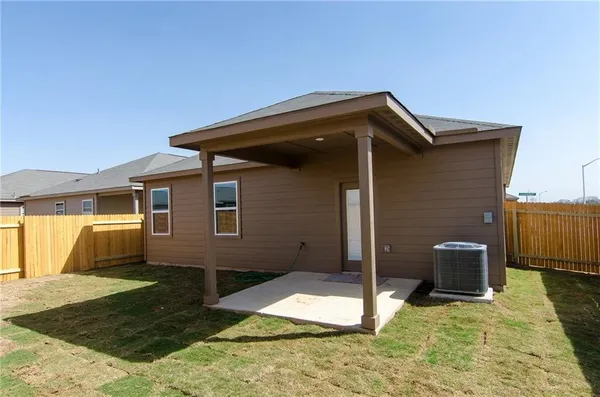 a backyard of a house with barbeque oven