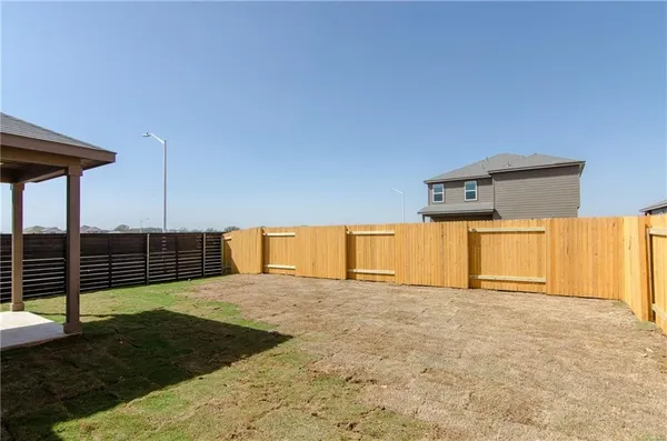 a view of a room with wooden floor and fence