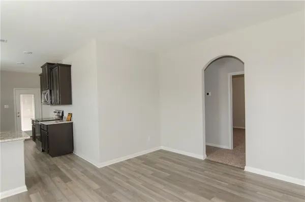 an empty room with wooden floor and mirror