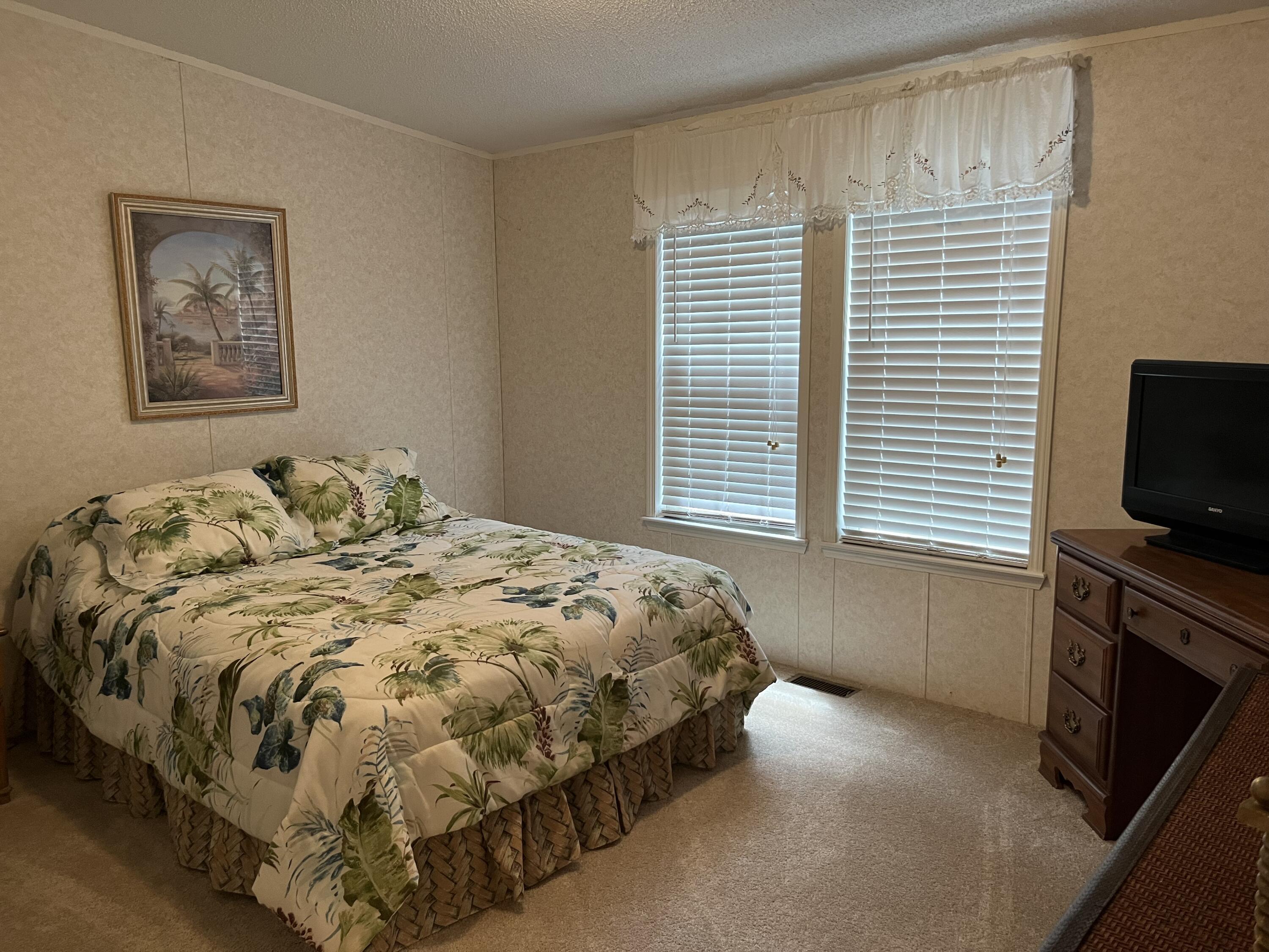 1104 Cat Island Road DeFuniak Springs, FL 32433 - Photo 19 of 28 a bedroom with a bed and a television