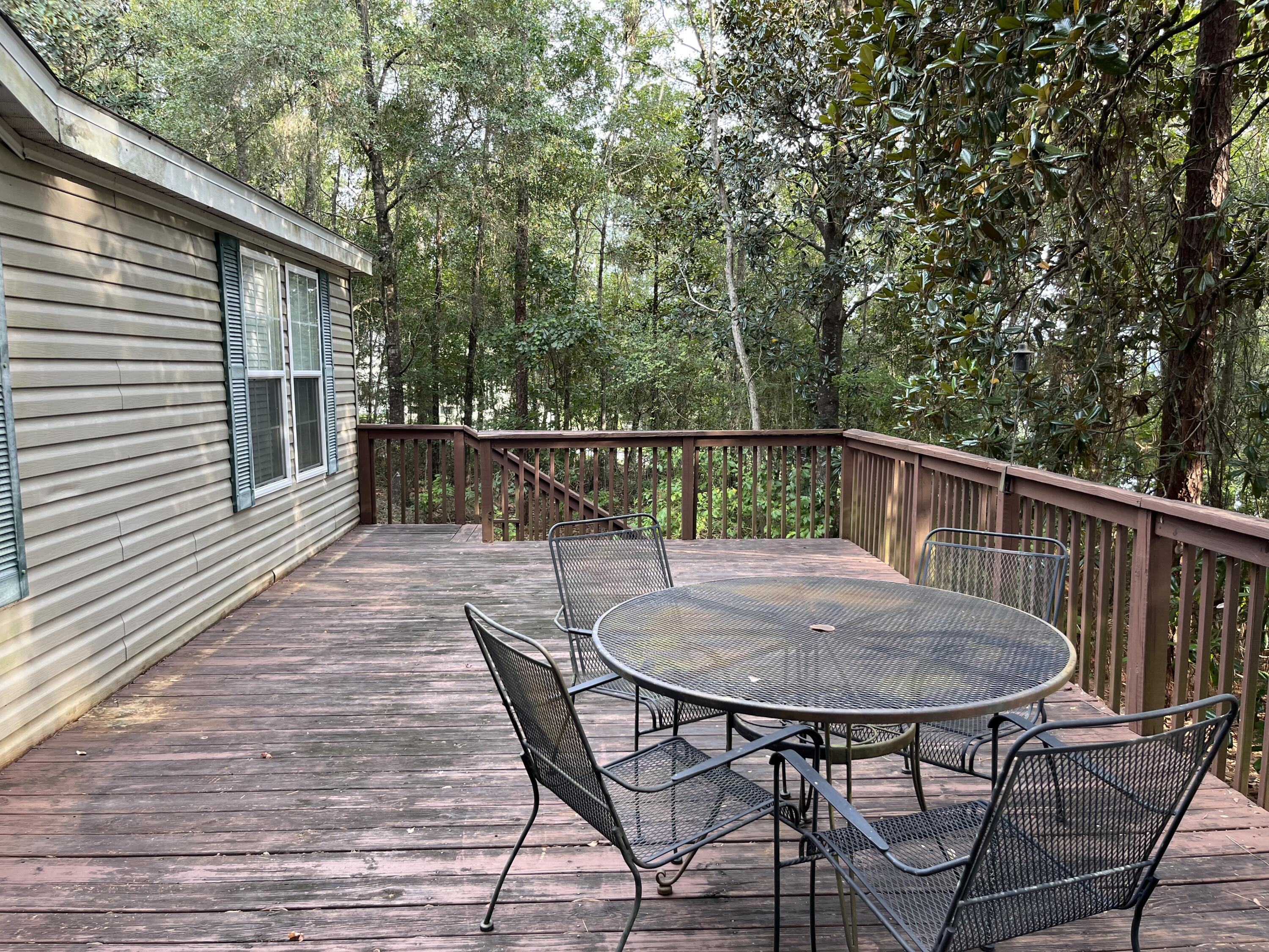1104 Cat Island Road DeFuniak Springs, FL 32433 - Photo 6 of 28 a view of a chairs and table on the deck