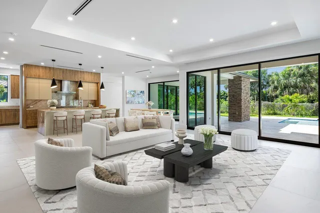 a living room with furniture and painting on the wall