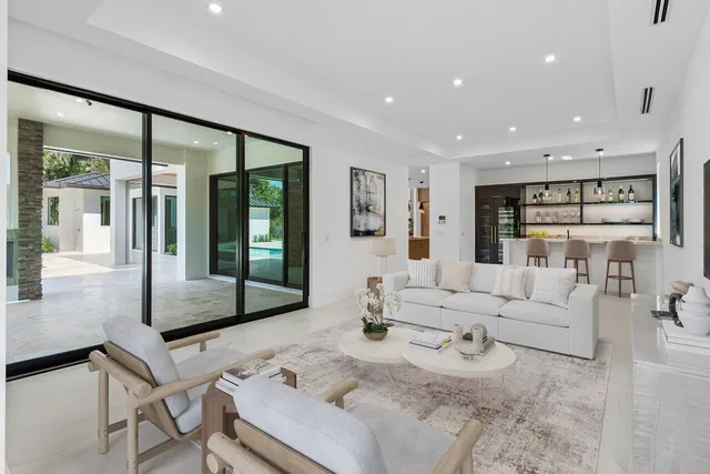a bathroom with a granite countertop sink a toilet and a window
