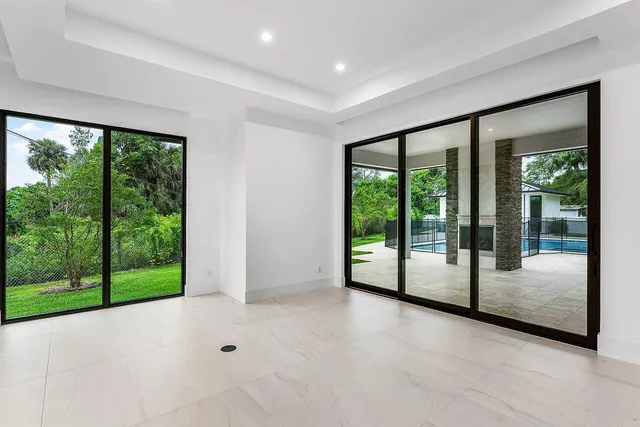 a view of kitchen with stainless steel appliances granite countertop a stove a sink and a microwave