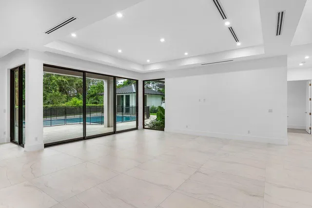 an aerial view of a house with a garden and swimming pool