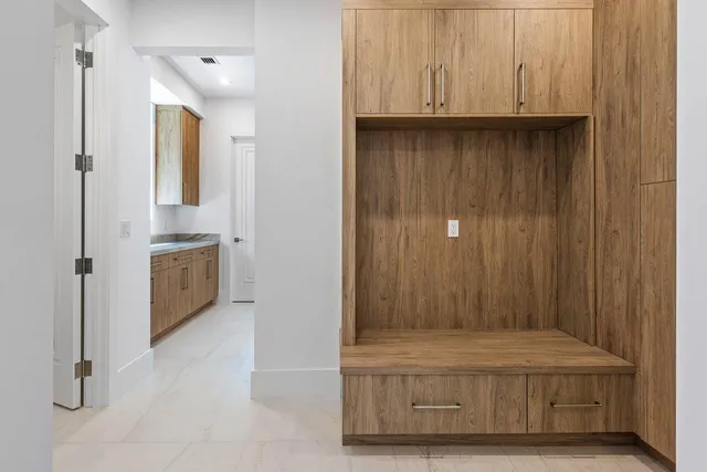 a front view of a house with a yard and tree