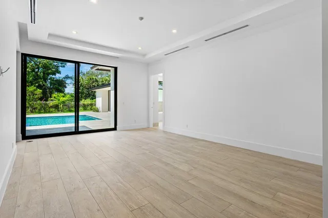 a view of an empty room with large windows