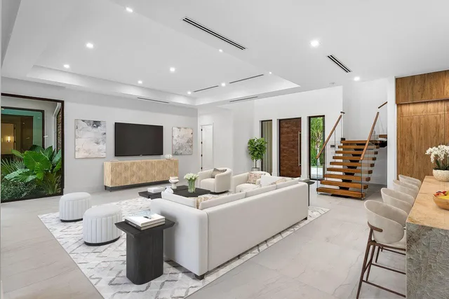 a large kitchen with stainless steel appliances kitchen island granite countertop a large kitchen island a stove and a sink